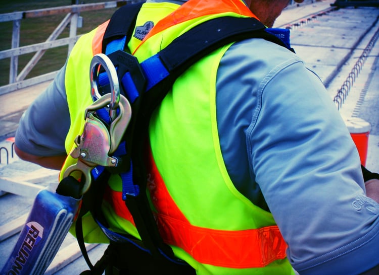 Worker using Reliance fall harness