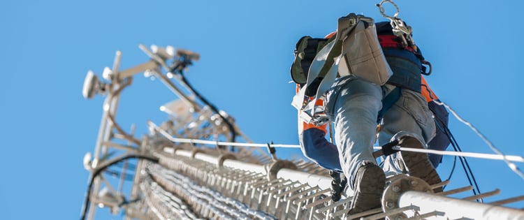 Worker climbing a cell tower